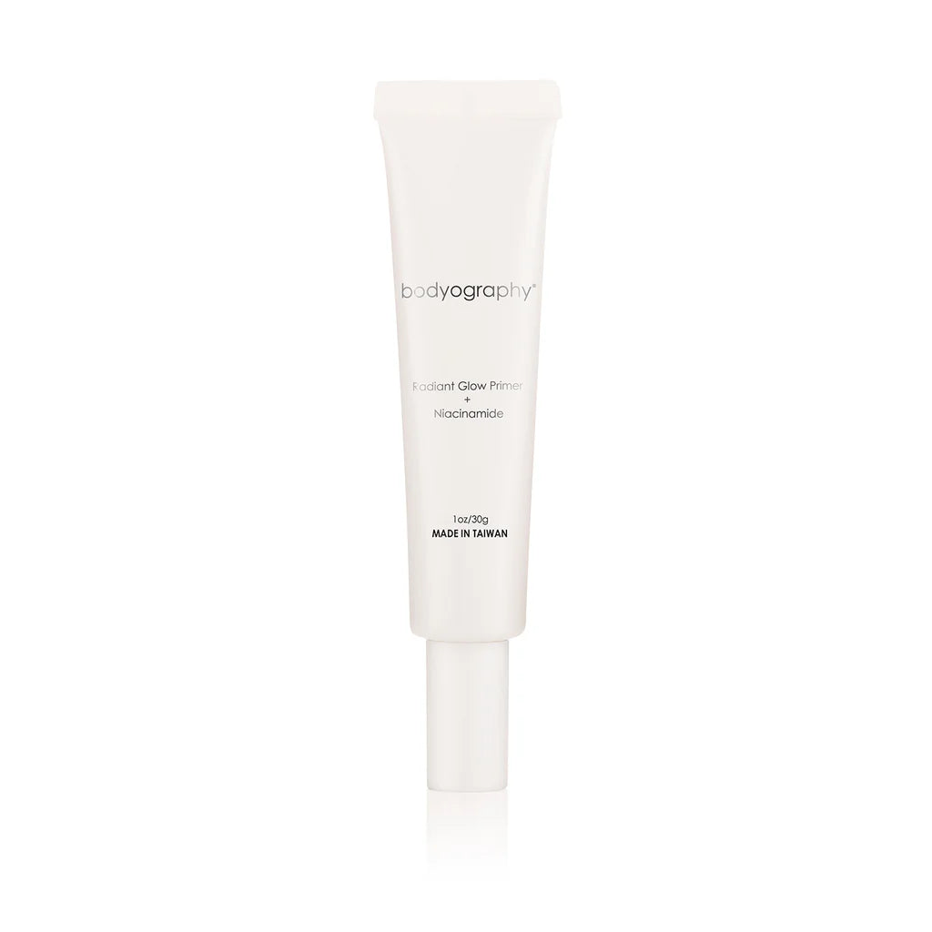 A white tube of Bodyography Radiant Glow Primer + Niacinamide, a hydrating primer with simple text labeling and a screw cap, is displayed against a plain white background.