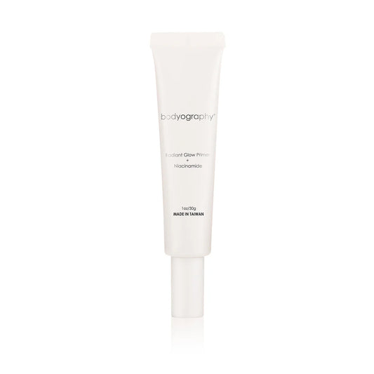 A white tube of Bodyography Radiant Glow Primer + Niacinamide, a hydrating primer with simple text labeling and a screw cap, is displayed against a plain white background.