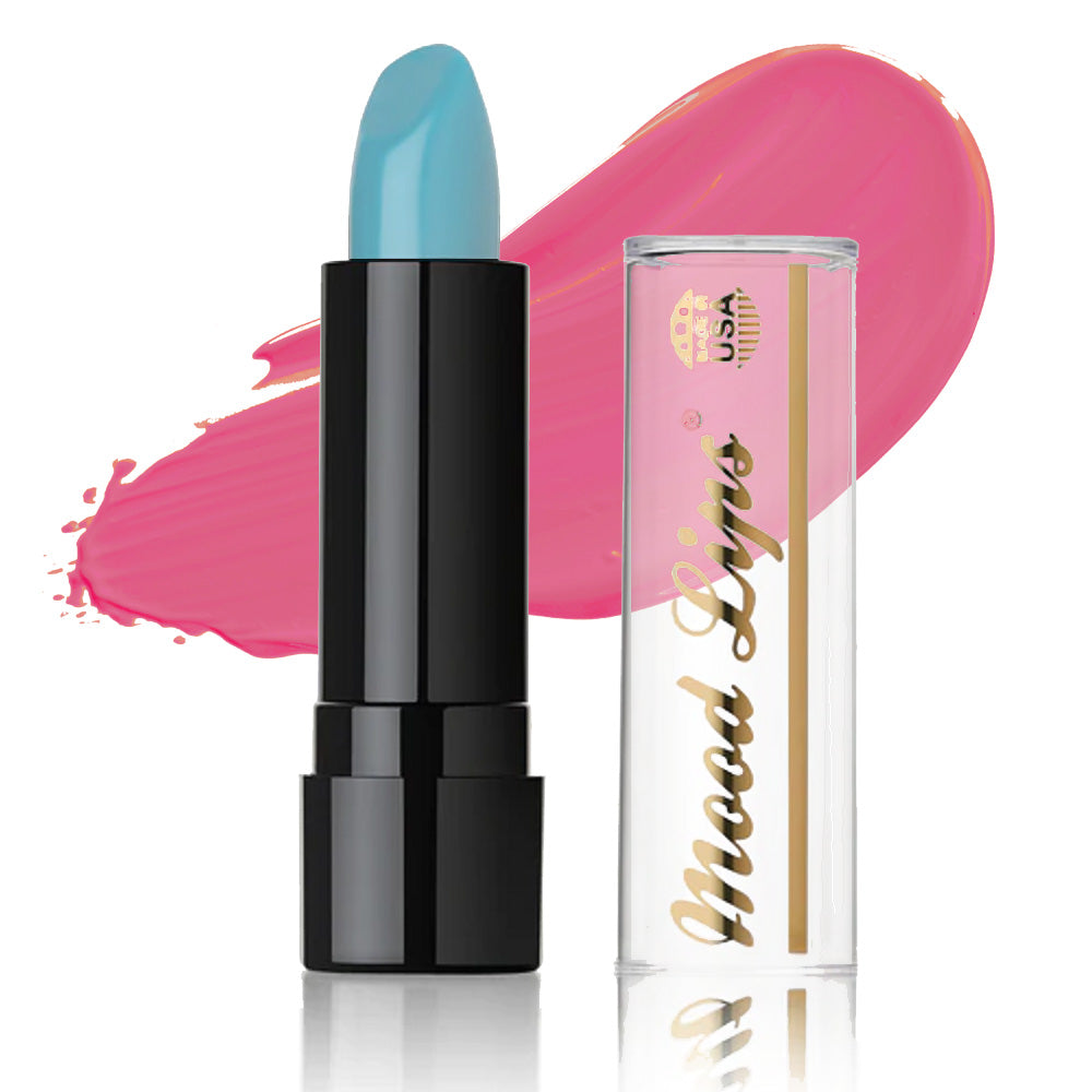 A blue Mood Lips Color Changing Lipstick in a black tube stands by a clear cap labeled in gold; behind them, a bright pink swatch from the long-lasting collection is smeared on a white background.