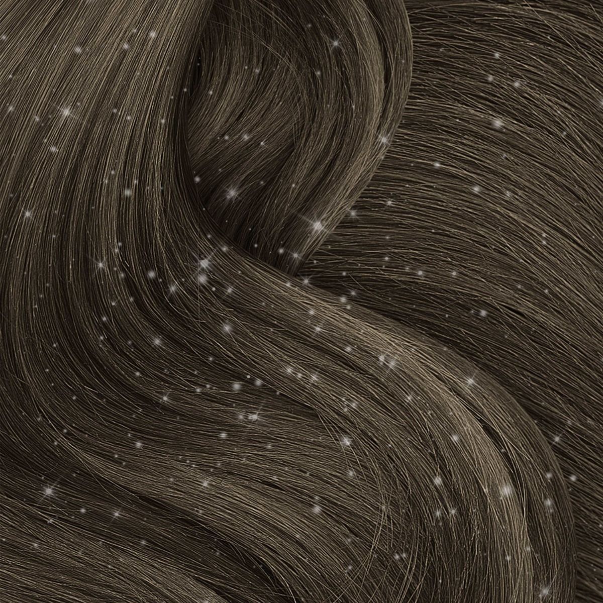 Close-up of brown hair strands with a smooth, wavy texture, dusted with white flakes and accented by Punky Temporary Hair and Body Glitter Spray 3.5 oz - Silver for a shimmering effect.