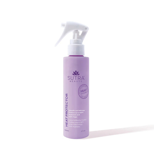 A lavender bottle of Sutra Heat Protector spray with a white nozzle, featuring purple and silver branding that highlights its protection against heat damage.