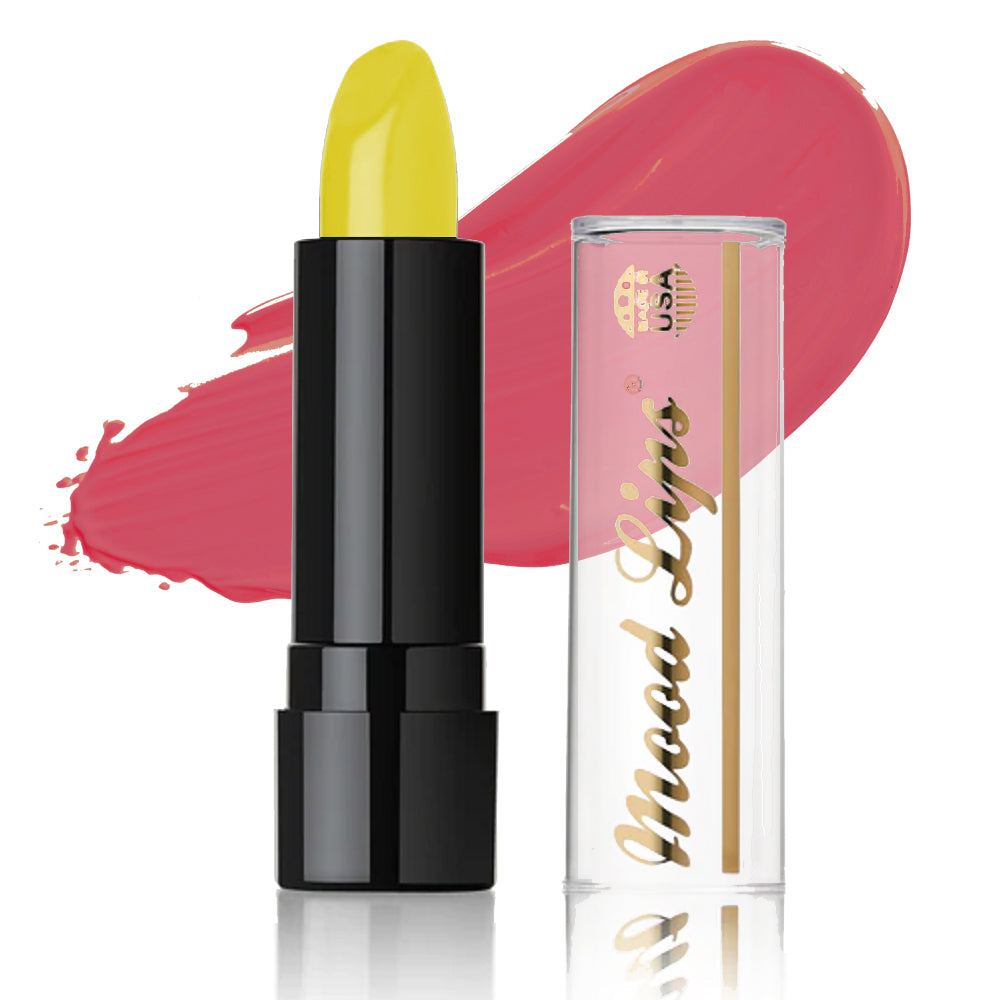 The Mood Lips Color Changing Lipstick, in a sleek black tube with Mood Lips written in gold, stands beside its clear cap. A vivid pink smear appears behind them, highlighting this vibrant and long-lasting lipstick.