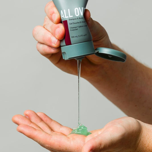 Johnny B. All Over Shampoo and Body Wash being poured from a tube into a hand