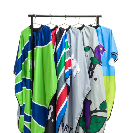 Johnny B. cutting cape collection featuring vibrant colors and stylish designs for professional barbers