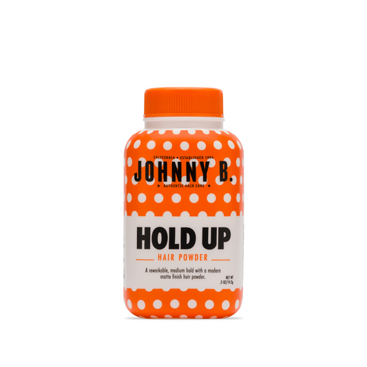 Johnny B Hold Up Hair Powder in a bright orange bottle with white polka dots for styling flexibility