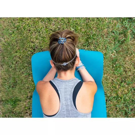 Teleties headband in use, holding hair in place during a workout on a yoga mat