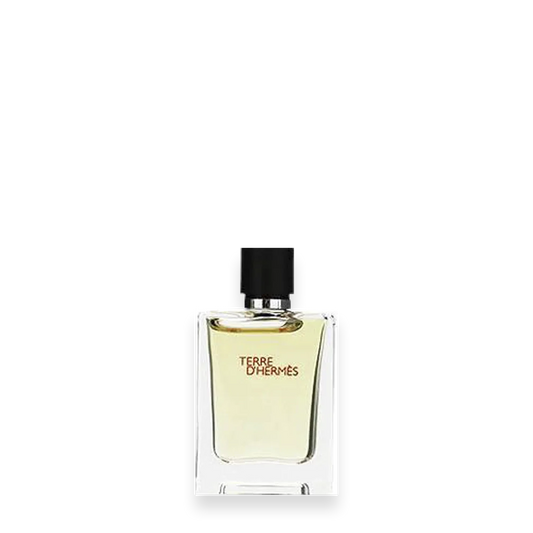 A clear glass bottle of Hermes Terre d’Hermes Parfum with a black cap and light yellow liquid inside, displayed against a white background.
