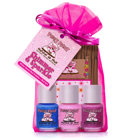 The Piggy Paint Shimmer & Sparkle Gift Set includes a pink organza bag holding three kid-friendly nail polish bottles—blue, light pink, and pale pink—with a gift tag featuring a pig cartoon.