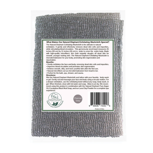 The Natural Elephant Exfoliating Shower Washcloth in Charcoal Gray is displayed in its packaging with a white label highlighting skin regeneration benefits and usage, and a barcode at the bottom right. Made from natural microfibers for textured exfoliation.