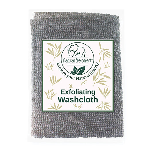 The Natural Elephant Exfoliating Shower Washcloth is a gray, textured cloth made from natural microfibers, featuring an elephant logo and leafy designs, with a label that reads Natural Elephant - Explore your Natural Beauty.