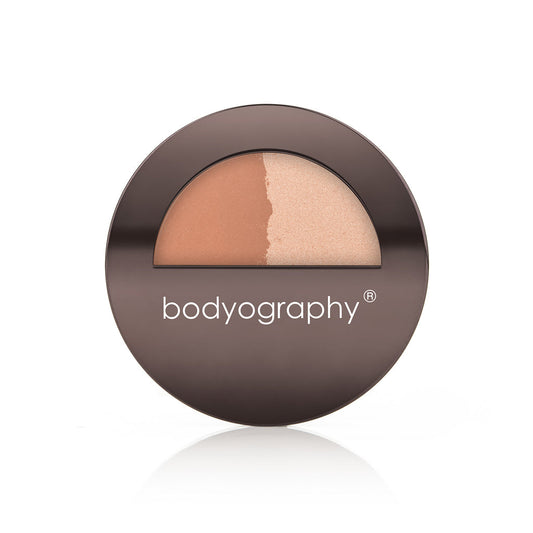 The Bodyography Highlighter Pressed Powder Sunsculpt Duo features a warm bronzer/highlighter and a champagne shade in a round, dark brown compact with “bodyography” in white on the lid for a radiant finish.