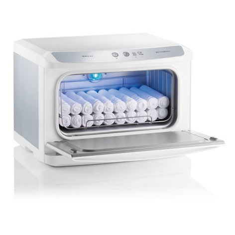The White Towel Services Taiji HC11-UVPro HotCabi Towel Warmer, shown with its front door open, displays neatly rolled white towels inside illuminated by a blue UV sterilization light for added hygiene.