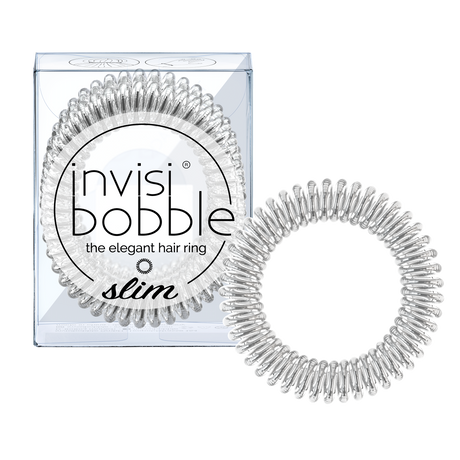 A clear, coiled Invisibobble Slim- Chrome Sweet Chrome hair tie is shown beside its transparent box with the brand name and the elegant hair ring in black text. This pack of 3 can also be worn as a stylish bracelet.