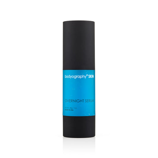 A 1 oz cylindrical bottle of Bodyography Skin Care Overnight Serum with a matte black finish and blue label, designed for collagen support and anti-aging benefits, stands upright on a white background.