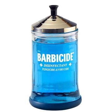 Barbicide jar midsize with blue disinfectant liquid for sterilizing tools and surfaces