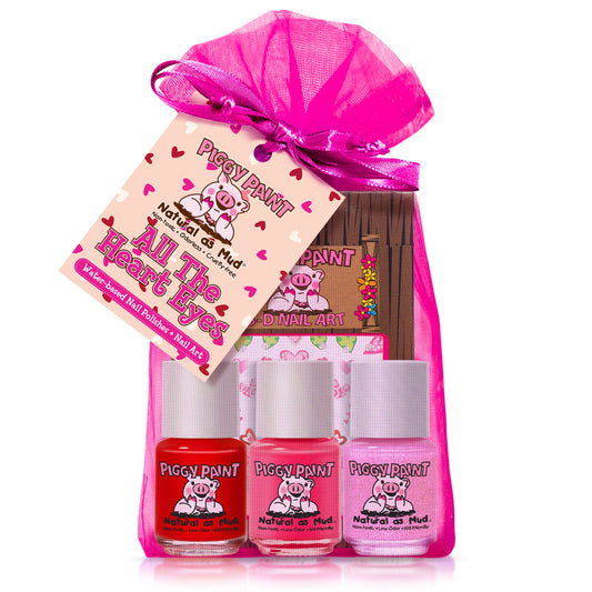 Piggy Paint gift set featuring three nail polish bottles in pink and red shades with a themed pink pouch