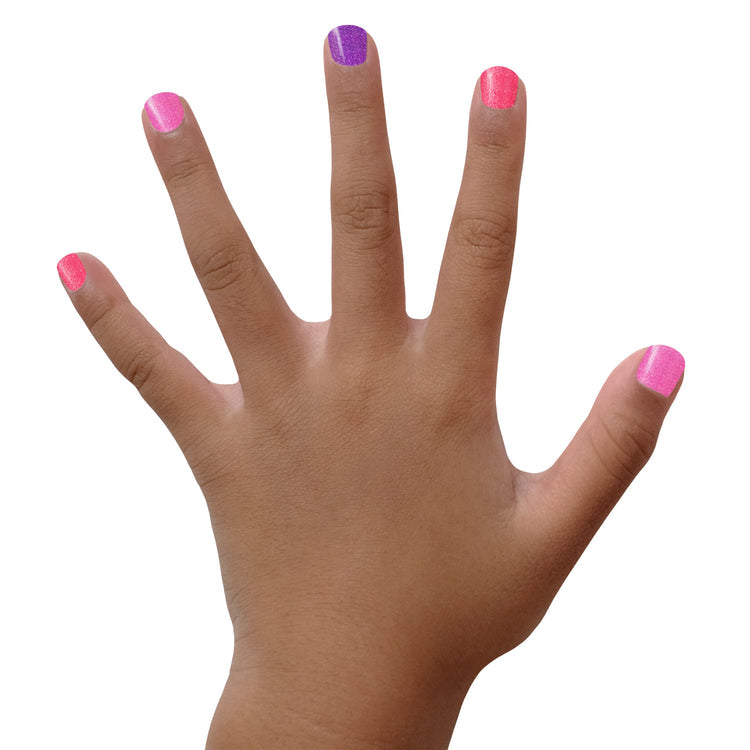 Colorful Piggy Paint gift set on a child's hand with pink and purple nail polish