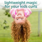 kids curly hair refresher spray showing smiling redheaded girl hanging upside down with bouncy curls outdoors