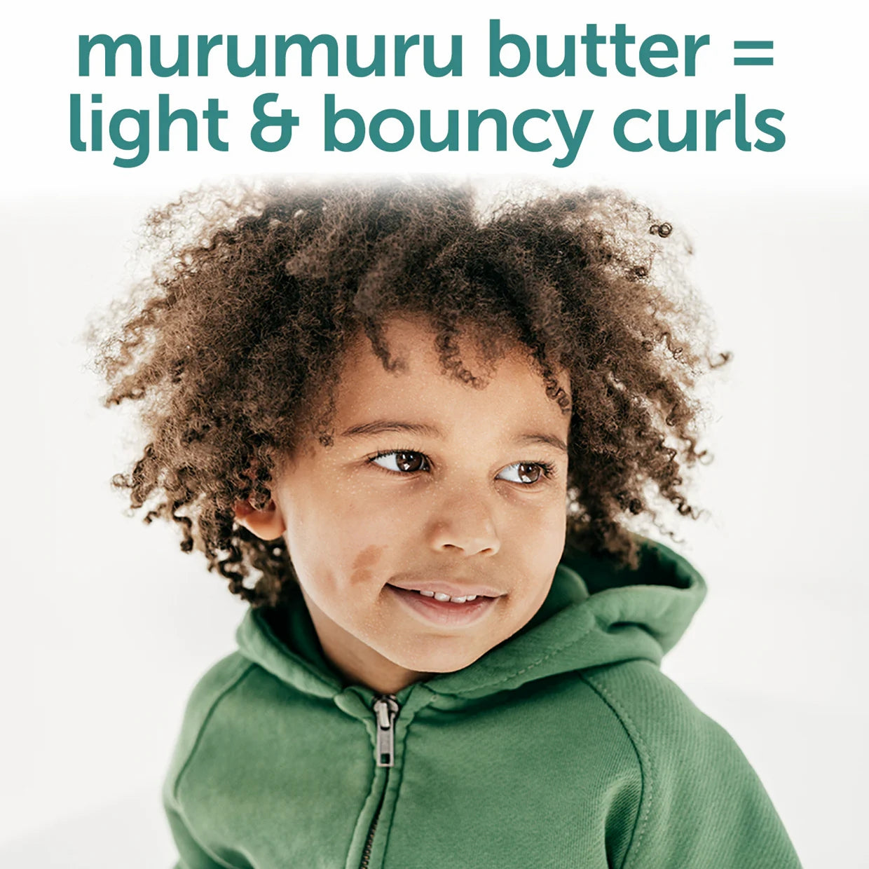 Fairy Tales kids curly hair shampoo showing smiling child with light bouncy curls wearing green hoodie