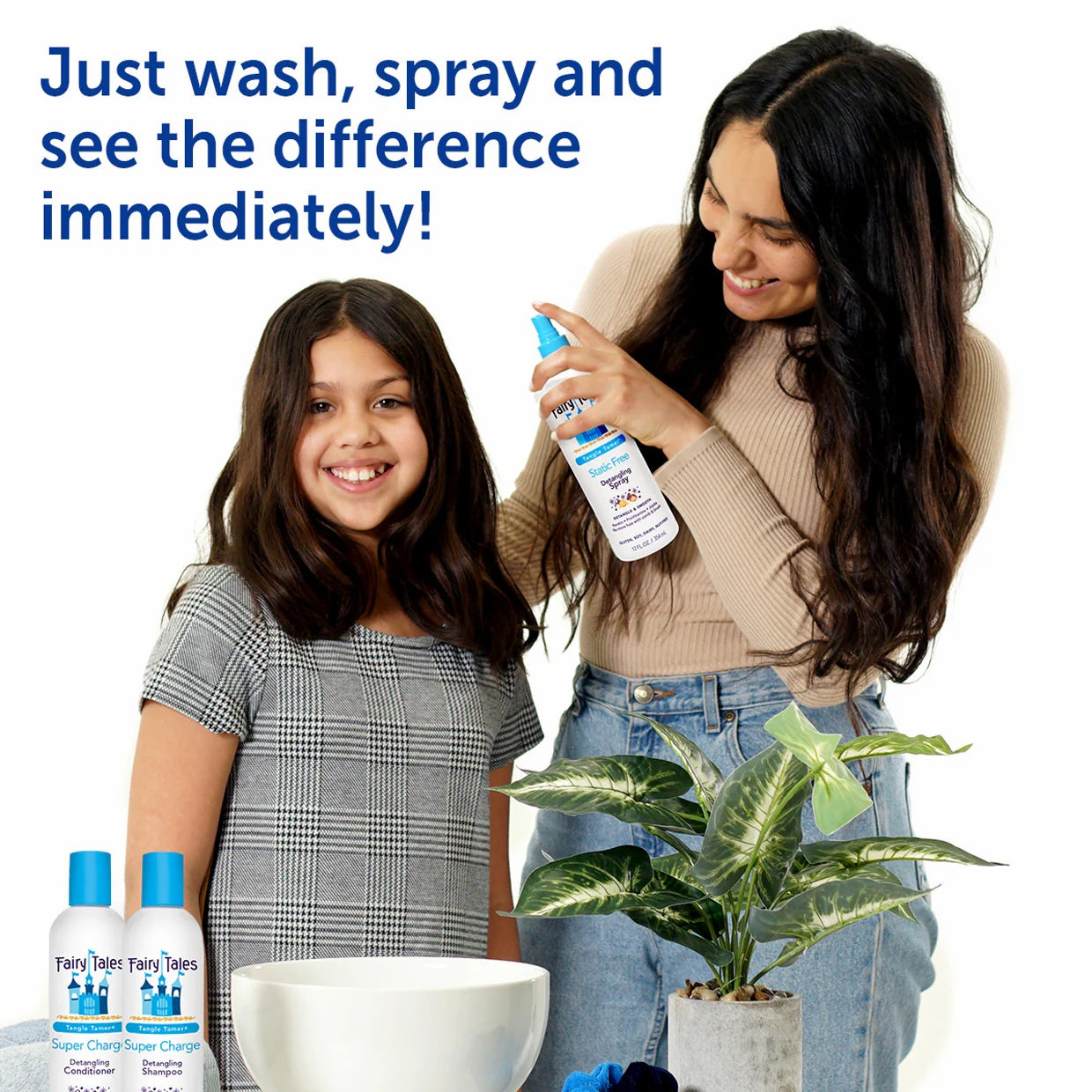 Mother spraying Fairy Tales kids detangling shampoo on smiling daughter with bottles and plant nearby