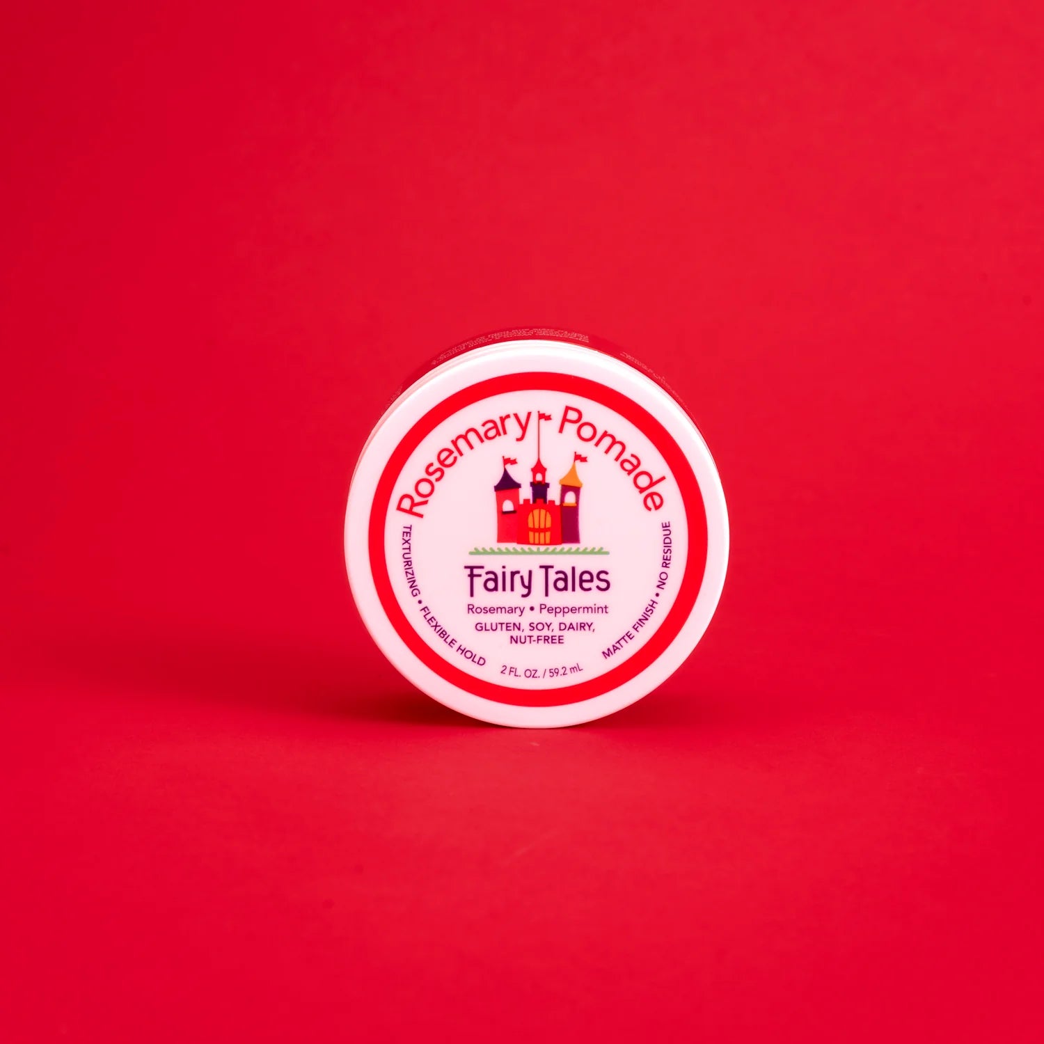 Fairy Tales Rosemary kids pomade in a round jar on a red background for styling children's hair