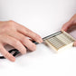 Hands holding a Feather Razor Blade with a protected case for safe storage and easy access