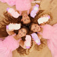 Three girls in pink dresses holding Glimmer Wish unicorn shampoo for kids, smiling and having fun