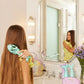 Glimmer Wish mermaid detangling hair brush held by a girl with long hair in a chic bathroom setting
