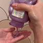 Glimmer Wish Unicorn Body Wash for kids being poured into a hand from a colorful bottle