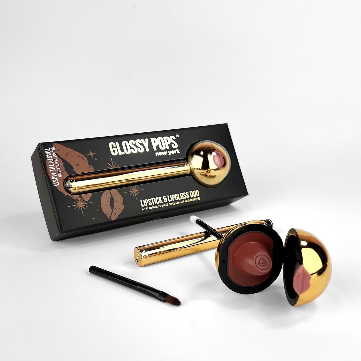 Glossy Pop Urban Lips Lipstick and Lip Gloss Duo in a stylish gold tube with an applicator brush