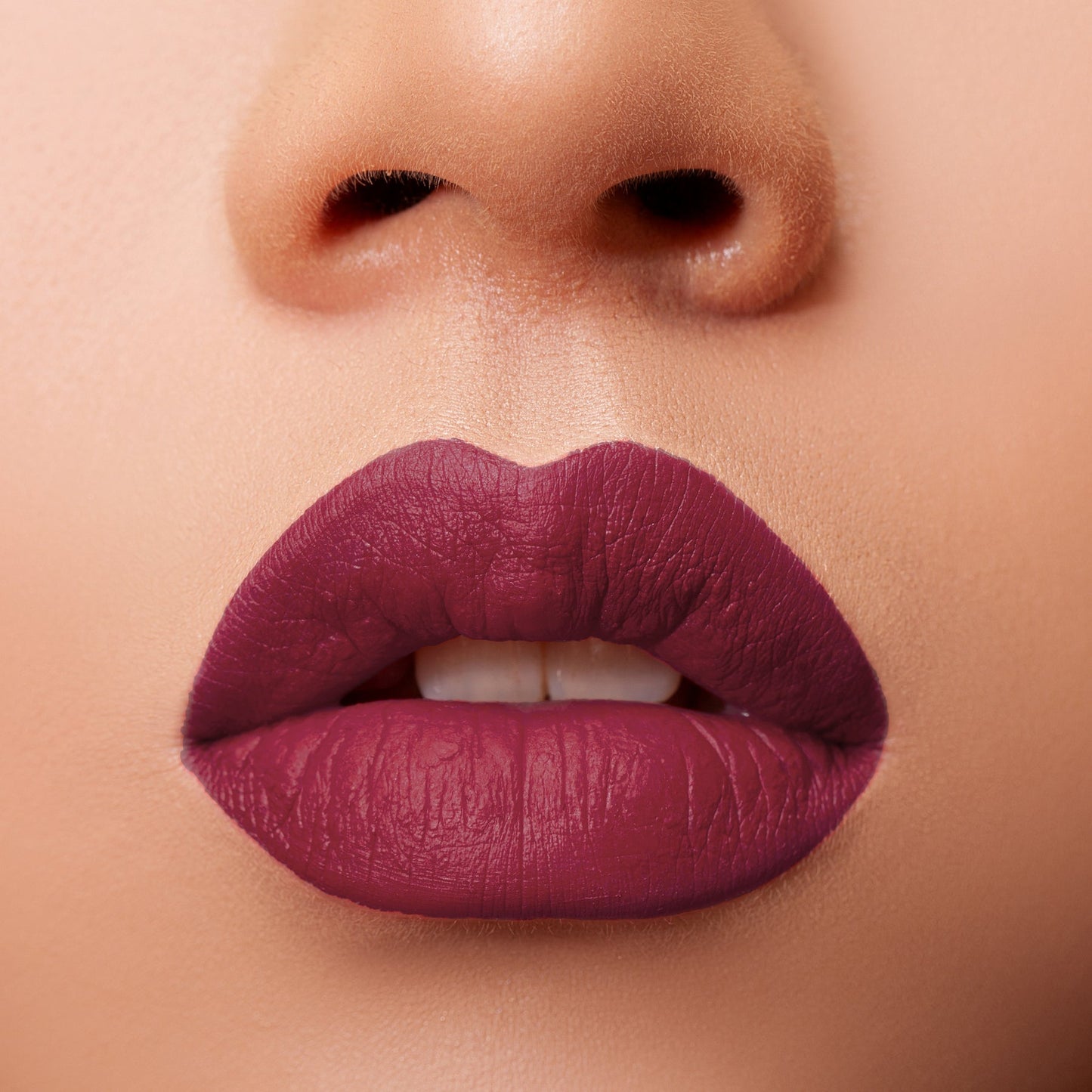 Close-up of lips wearing Glossy Pop Urban Lips Lipstick in a rich plum shade