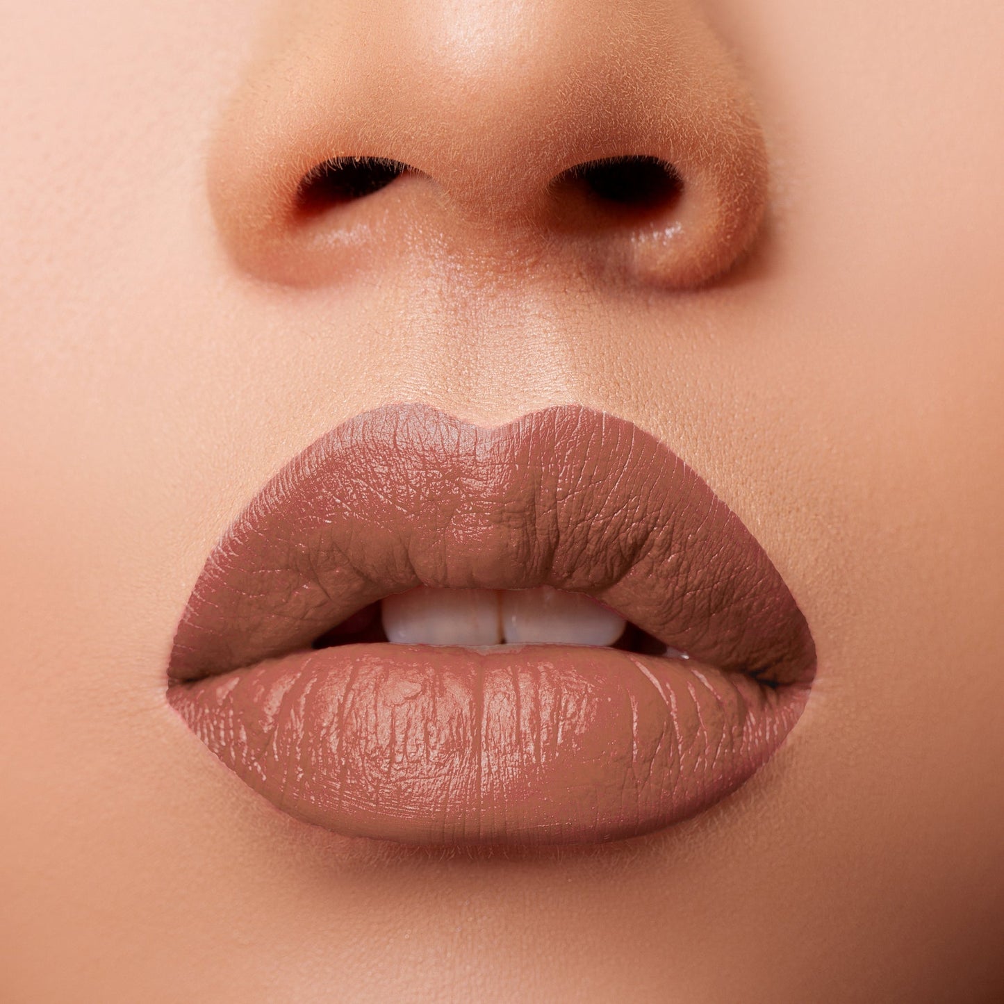 Glossy Pop Urban Lips Lipstick in a natural nude shade applied on full lips for a smooth finish