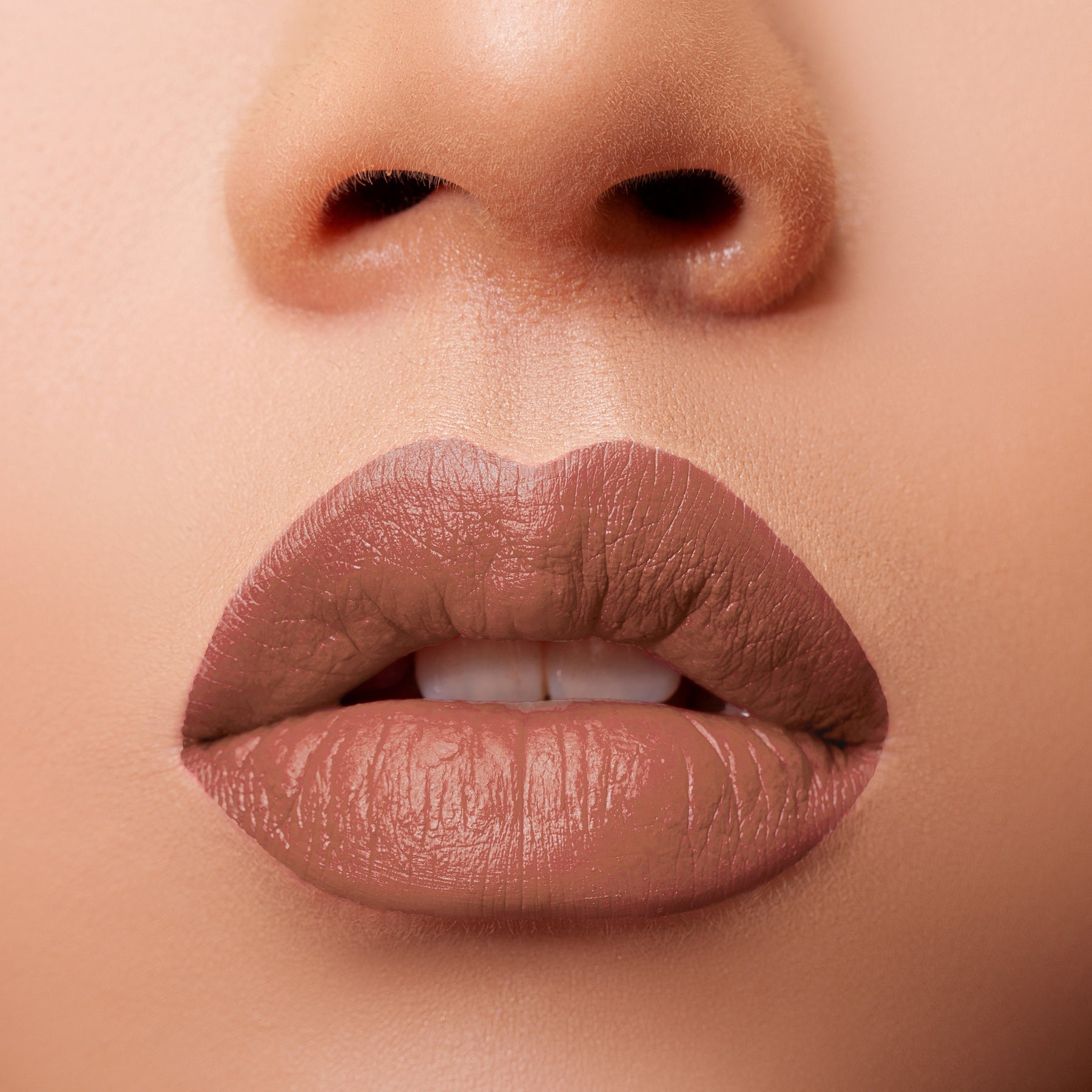 Glossy Pop Urban Lips Lipstick in a natural nude shade applied on full lips for a smooth finish