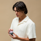 Johnny B Lava Clay Pomade in a male model's hand for styling and grooming hair