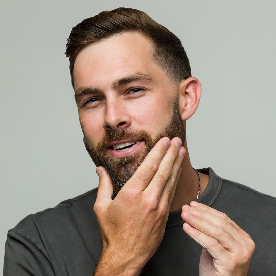 Man applying Johnny B leave-in conditioner for healthy, manageable hair and beard styling