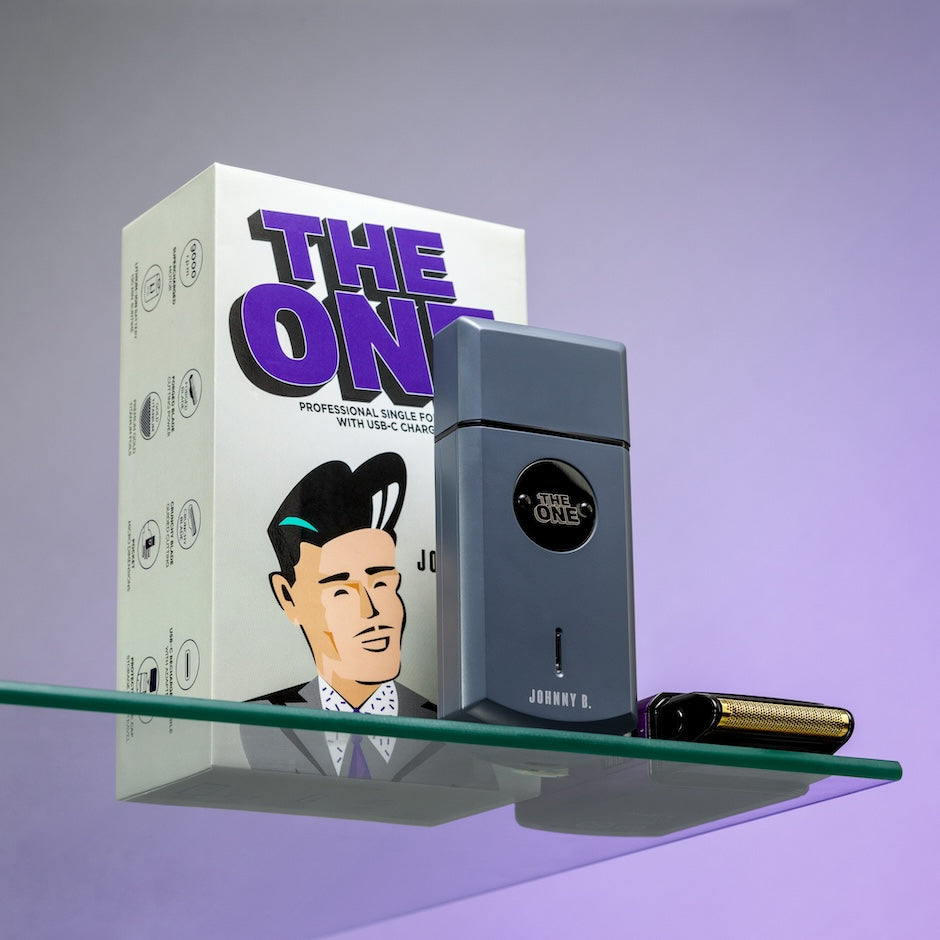 Johnny B The One shaver displayed with box on a glass shelf, designed for professional grooming
