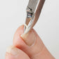 Seki Edge nail nipper trimming a hangnail on a fingertip for precise nail care
