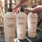 Original Sprout Luscious Island Conditioner bottle among other hair care products in a tropical setting