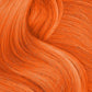 Vibrant orange hair styled with Punky Colour temporary hair color spray for a bold look