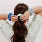 Teleties silk hair scrunchies for women in blue and green tones holding back beautiful hair.