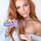 Unbrush detangling hair brush being used on long, wavy red hair for easy styling