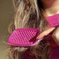Unbrush mini detangling hair brush with vibrant pink design for effortless hair styling