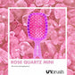 Unbrush Rose Quartz mini detangling hair brush on a bed of pink quartz stones