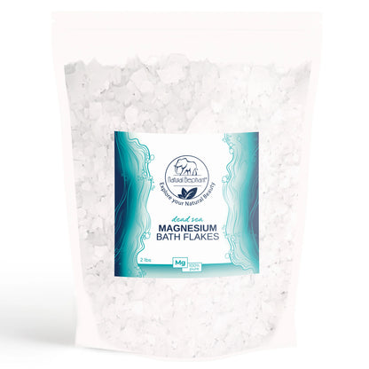 A white resealable bag of Natural Elephant Dead Sea Magnesium Flakes, 2 lbs, with a blue and white label featuring the product name and description. The coarse white flakes provide muscle relaxation from pure Dead Sea magnesium.