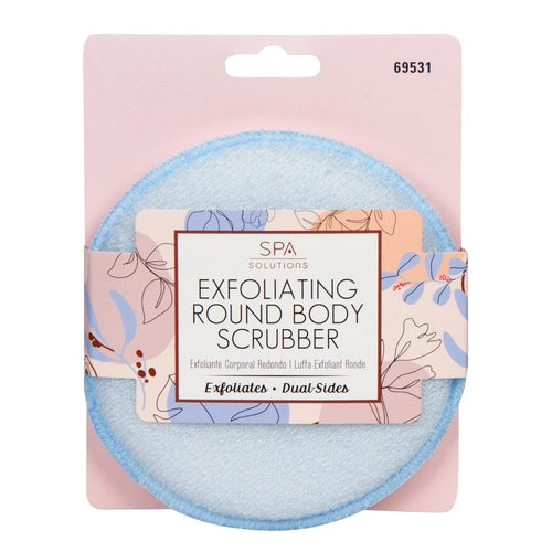 A packaged Cala Exfoliating Round Body Scrubber with a light blue edge is shown against a pink and floral background. The label reads Exfoliates • Dual-Sides, ideal for deep cleansing and dead skin removal.
