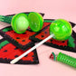 Glossy Pops TGI Fruity lip balm in a fun green watermelon-inspired packaging with a shiny finish