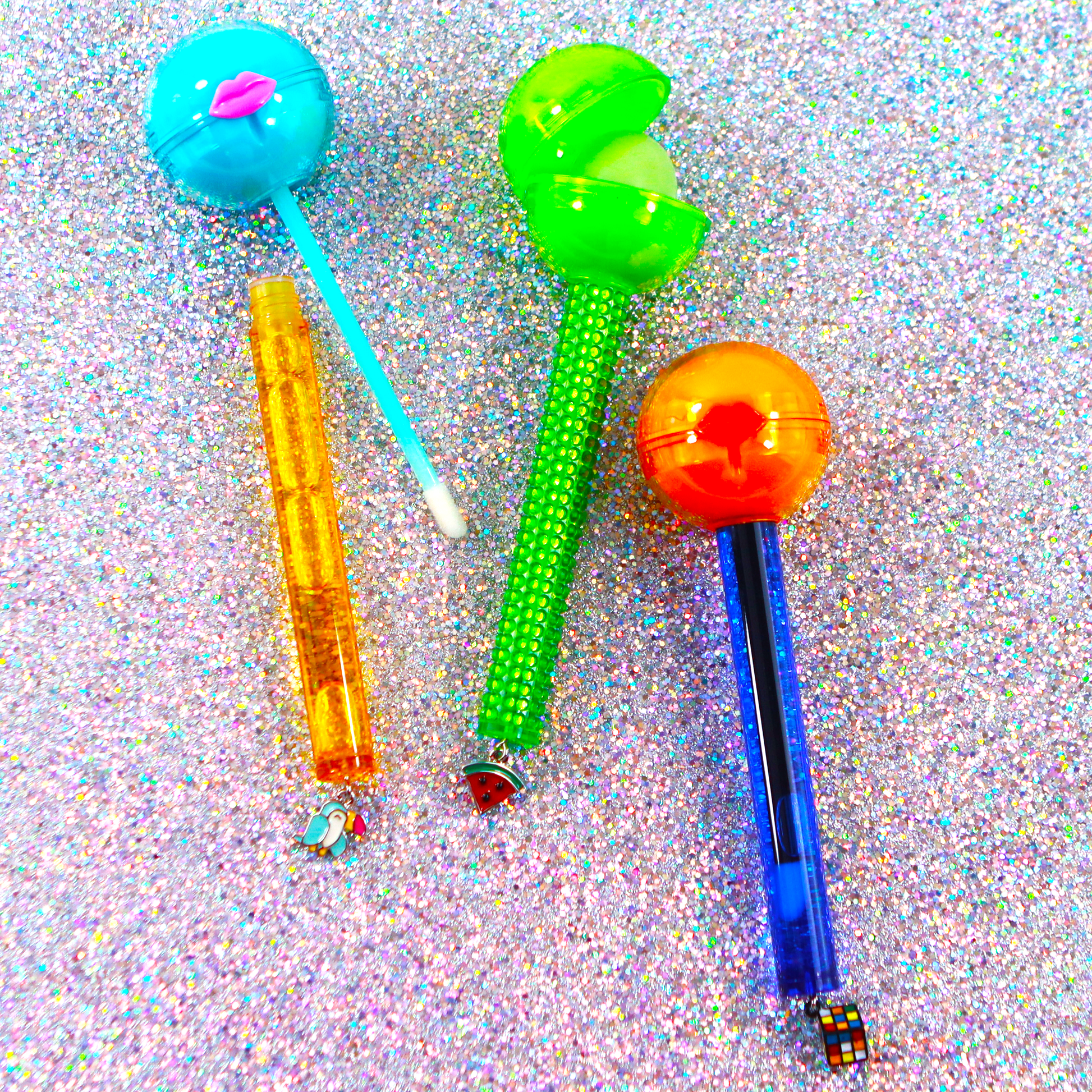 Glossy Pops TGI Fruity lip balm in colorful containers for moisturizing lips and fun application