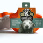 Groom Genie pet detangling brush in orange with packaging that calms and grooms any pet's fur