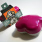 Groom Genie pet detangling brush in pink with packaging showing it calms and grooms pets quickly