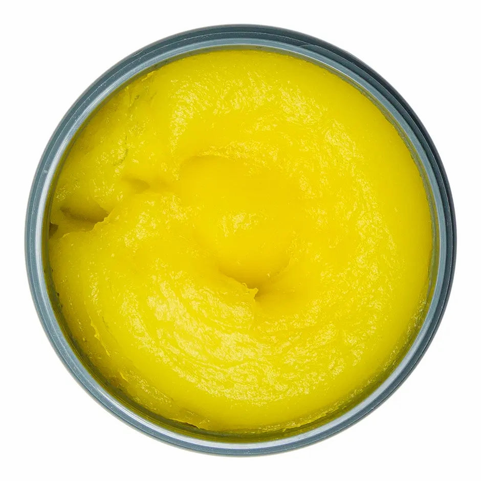 Top view of Johnny B Fuddy Matte Gel in a tin container showcasing its vibrant yellow texture